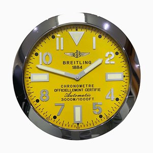 Orologio da parete cronometro con quadrante giallo e lunetta scanalata di Breitling