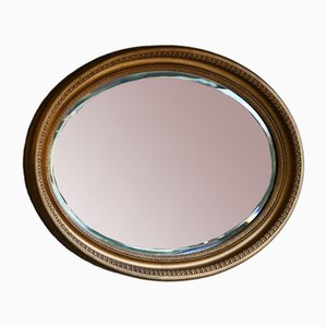 Espejo oval dorado de principios del siglo XX