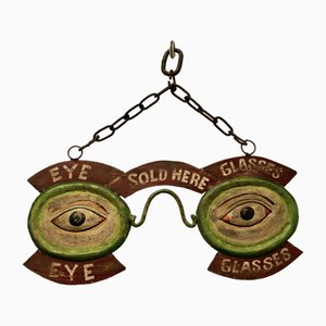 Cartel comercial de escaparate de ojos y gafas, años 30