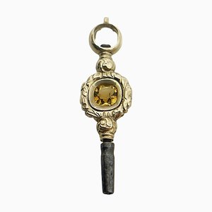 Chiave da orologio in ottone e oro con pietra di citrino, XIX secolo