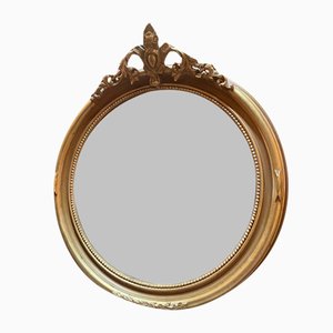 Espejo ovalado de madera dorada