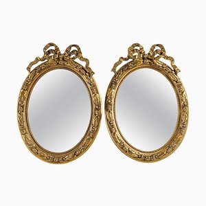 Espejos estilo Luis XVI de madera y estuco dorado. Juego de 2