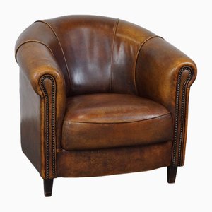 Club chair in pelle di pecora con cuscino di seduta fisso