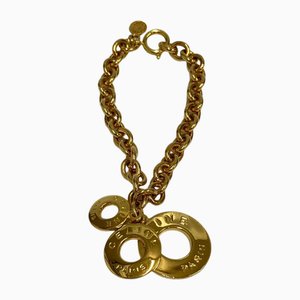 Brazalete de tres cadenas con logo circular vintage en dorado de Celine