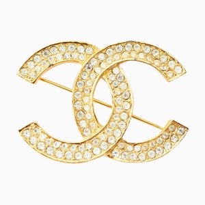 Broche CHANEL ici marque strass or