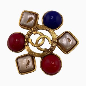 Gefälschte Vintage Coco Mark Brosche aus farbigem Stein in Gold von Chanel