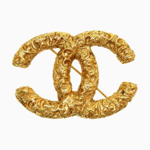 Spilla CHANEL Cocomark Lava 95A in metallo dorato