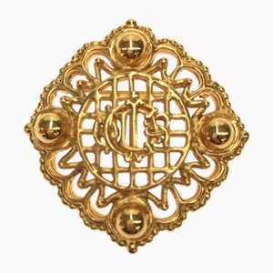 Broche con escudo de armas en dorado de Christian Dior