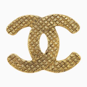 Broche con logo CC tejido en dorado de Chanel