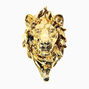 Servilletero de bronce dorado que representa la cabeza de un león, siglo XX