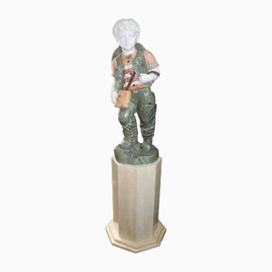 Figura infantil de vendedor de uvas sobre pedestal, años 70, mármol