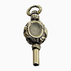 Uhrenschlüssel aus Messing & Gold, 19. Jh., mit 2 verschiedenfarbigen Steinen