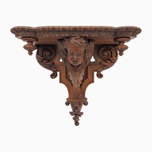 Wandkonsole aus geschnitztem Holz mit Putti
