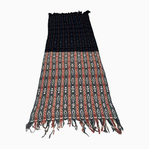 Tela Ikat tradicional de Indonesia en rojo, negro, amarillo y azul