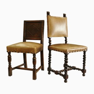 Set of Jacobean Oak Carved Hall Chairs One with Barley Twist, Carved Lion Pediments Both with Brass Studs and Leather Upholstery