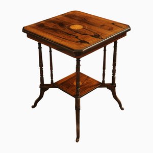 Mesa auxiliar de dos niveles Imperio francés con incrustación de palisandro con soportes torneados y ruedas de porcelana