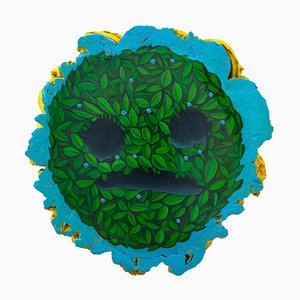 Sad Face Emoji on Cork Wood with Vibrant Green Plants