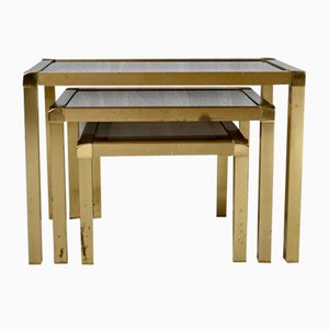Hollywood Regency Style Nesting Tables or Flying Tables in Gold Metal and Smoked Glass, 1970s, Set of 3