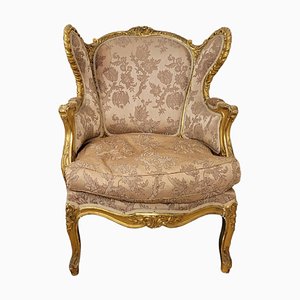 Sillón de madera dorada estilo Luis XV