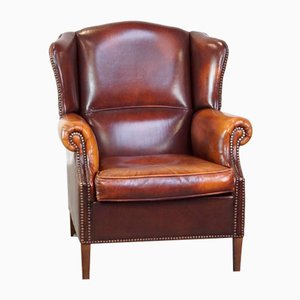 Sillón de orejas de cuero coñac