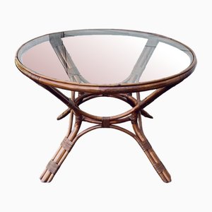 Mesa redonda de ratán y mimbre con tablero de vidrio, años 70