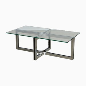 Mesa de centro esculpida con base de cromo con tablero de vidrio