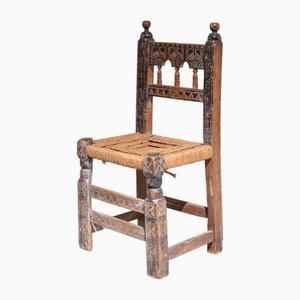 Silla rústica española primera mitad del siglo XX tallada a mano con asiento de totora, España, década de 1890