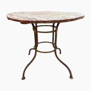 Mesa de jardín de hierro forjado con tablero redondo