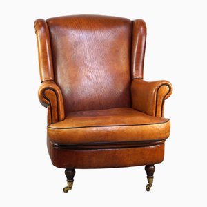 Subtle and Well-Maintained Sheep Leather Armchair on Brass Front Wheels