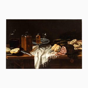 Sconosciuto, Natura morta con salame, pane, biscotti e bottiglie di vetro, Dipinto ad olio, XVII secolo