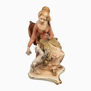 Sculpture Vintage en Biscuit en Céramique d'une Femme Assise avec un Chien de Capodimonte, 1960s