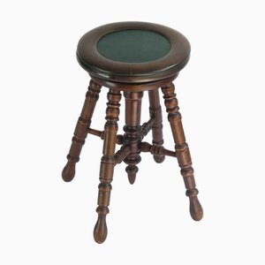 Taburete de piano antiguo original de madera con cuero verde y asiento ajustable