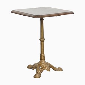 Mesa de bistró francesa antigua con pata de hierro fundido dorado y tablero de roble oscuro