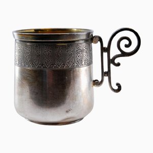 Silver Cup with Scrolls Handle and Relief Rim