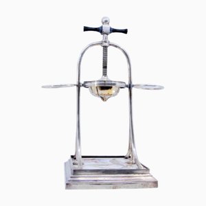 Silver Fruit Juicer with Floral Motifs and Wooden Base