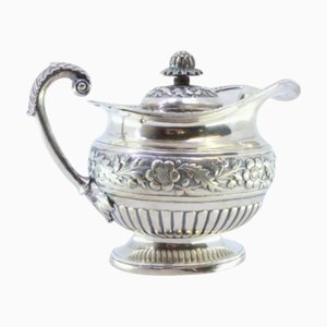 Silver Milk Jug with Raised Floral Motifs, Handle Rim Friezes, Acanthus Leaf Application and Flower-Shaped Lid Knob