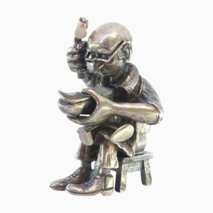 Figur eines sitzenden Schuhmachers, der Schuhe in Silber repariert