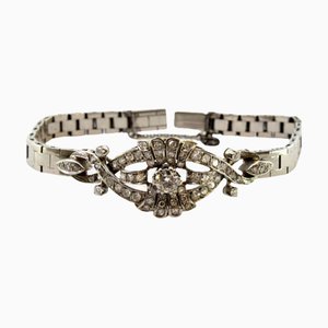 Bracelet en or blanc avec diamants centraux taille brillant et chaîne de sécurité