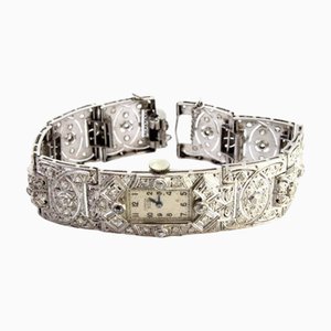 Uhr aus Platin mit gegliedertem Armband, Diamanten im Brillantschliff und Chips, mit Sicherheitskette