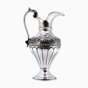 Silver Water Jug with Reliefs, Applications, Gold Interior and Circular Base with Frieze