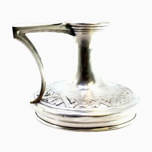 Rundes silbernes Paddel mit erhabenen Blumenmotiven