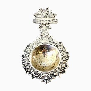 Silver Tea Strainer with Reliefs, Applications and Caravel Cut-Out Handle