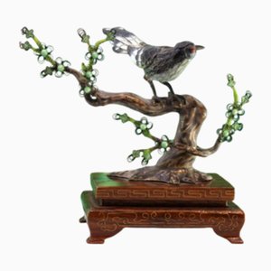 Pájaro de plata esmaltada con ramas cortadas