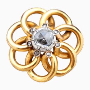 Goldbrosche mit verschlungenen Schleifen und Diamant