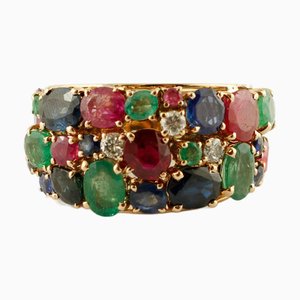Anillo vintage de oro rosa de 18 kt con rubíes, esmeraldas y zafiro azul