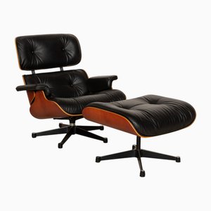 Set aus Sessel und Fußhocker aus schwarzem Leder von Charles & Ray Eames für Vitra