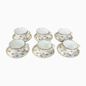 Tazas y platillos de porcelana con bordes dorados y motivos florales de Meissen, años 50. Juego de 12