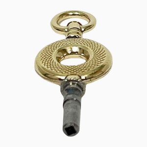 Llave de reloj de latón y oro, siglo XIX