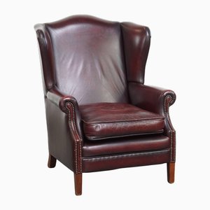 Poltrona a orecchioni in vacchetta rosso bordeaux