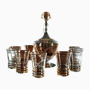 Decantador y vasos bañados en oro, años 50. Juego de 10